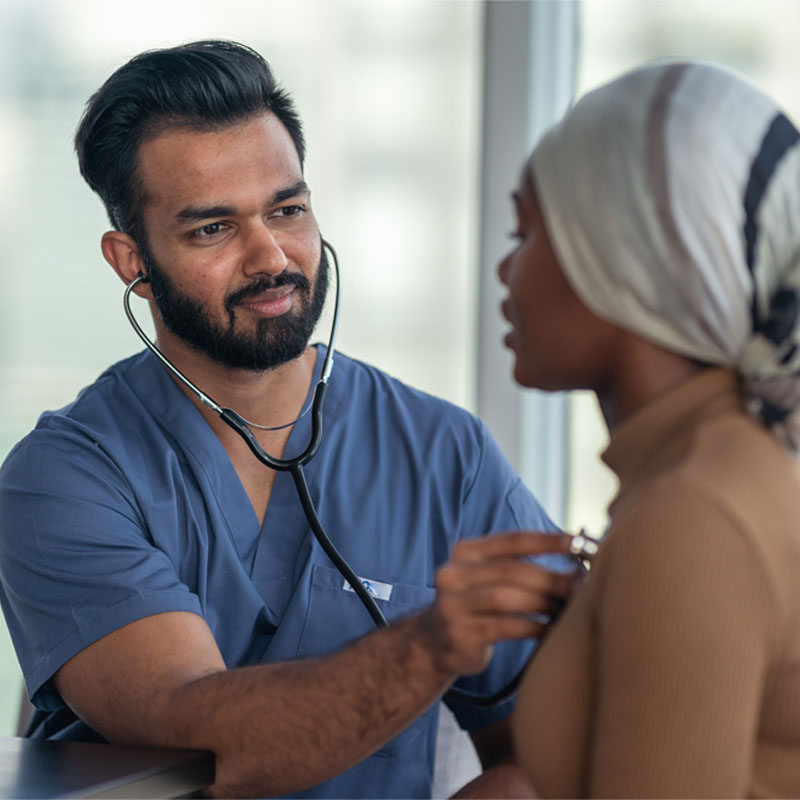 Male doctor meeting with female patient fighting cancer