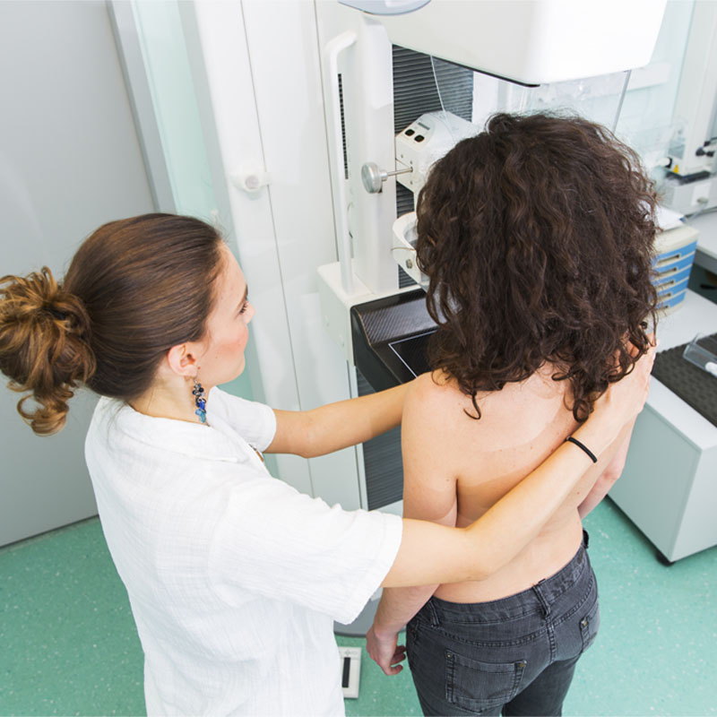 Nurse with young women having a mammography